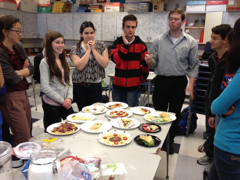 French teacher James Curly samples a crepe made by one of his students. Students in Curly’s French 4 Honors class made different types of French food on Mar. 14.