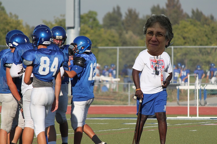 Newly appointed coach, Linda York, leads team in rigorous drills during practice. 
