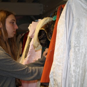 Elizabeth Rutherford looks through the costumes for Into the Woods. Photo illustration by Rifa Akanda. 