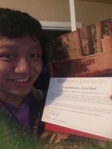 Senior Jezreel Real smiles as he holds up his acceptance letter to Whitworth University in Washington. 