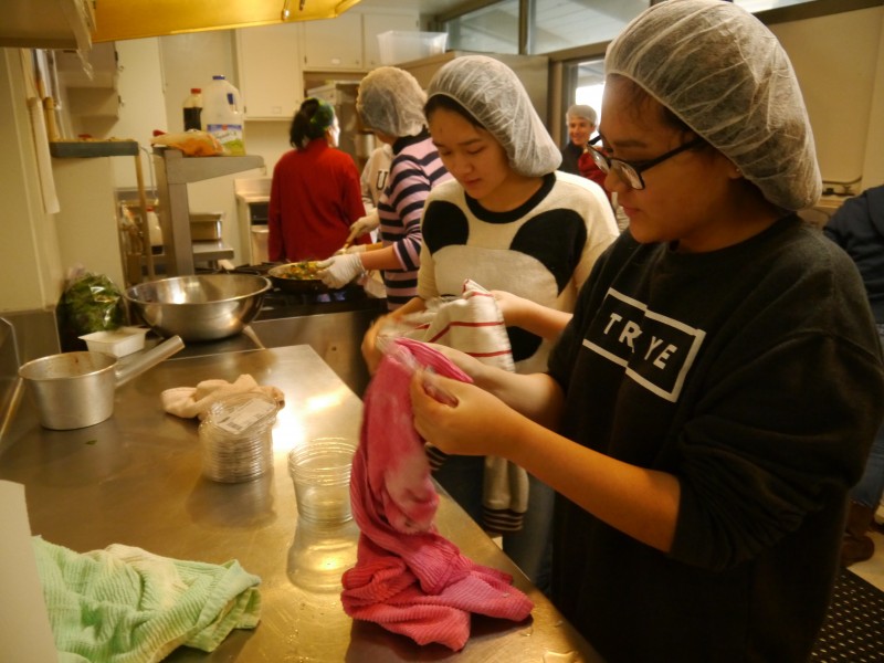 Senior Angie Deng and junior Anna Deng help out in the kitchen for Davis Community Meals.