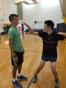 Junior Dylan Lee tries out an eye gouge on junior Alex Dhond.