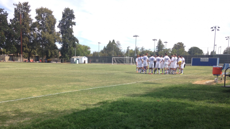 Davis High huddles around preparing to face Vacaville High School in the opening scrimmage.