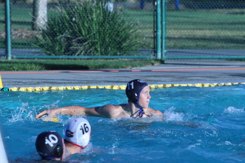 Junior Cameron Wright fires a shot in friday’s Water Polo game