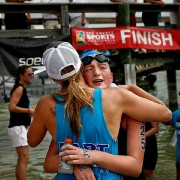 Senior Chenoa Devine embraces her coach after finishing a grueling 10k at Open Water Nationals in Fla. Courtesy photo by Chenoa Devine