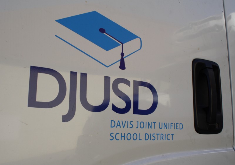 The Davis Joint Unified School District Logo is pictured on a truck, parked at the DJUSD Operations center. 