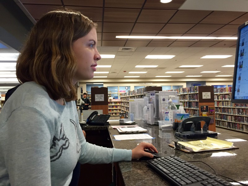 Senior Claire Drown works at the computer help desk at the Yolo County Library.