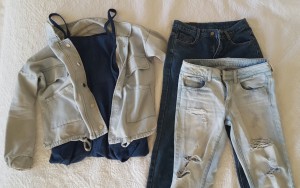 Denim jackets and distressed boyfriend jeans are some of the denim articles dominating fashion right now. A denim jumpsuit is paired with a denim jacket to create a denim on denim outfit.