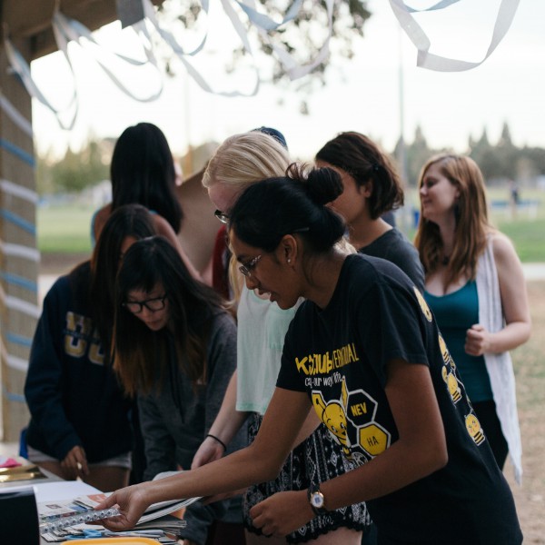 Key Club President Preethi Bhat picks some construction paper for the costume competition with Senior Anya McHugh during the Fall Social in October 2015.