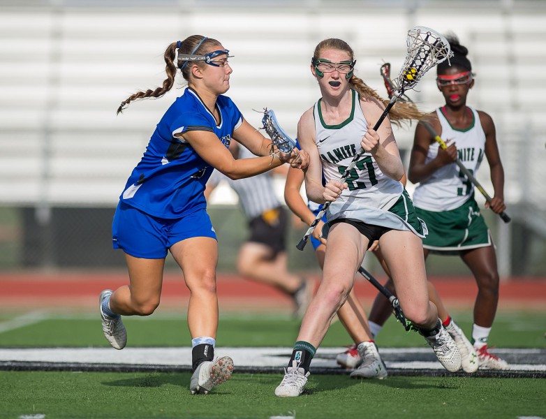 Senior Anna Belenis body-checks a Granite Bay attacker.