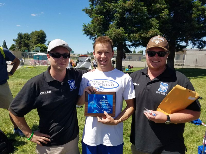 Senior Owen Yancher poses with coaches John Varley (left) and Paul Dailey (right) while holding the women's swim team's second-place Sac-Joaquin Section plaque. (Courtesy: L. Yancher)