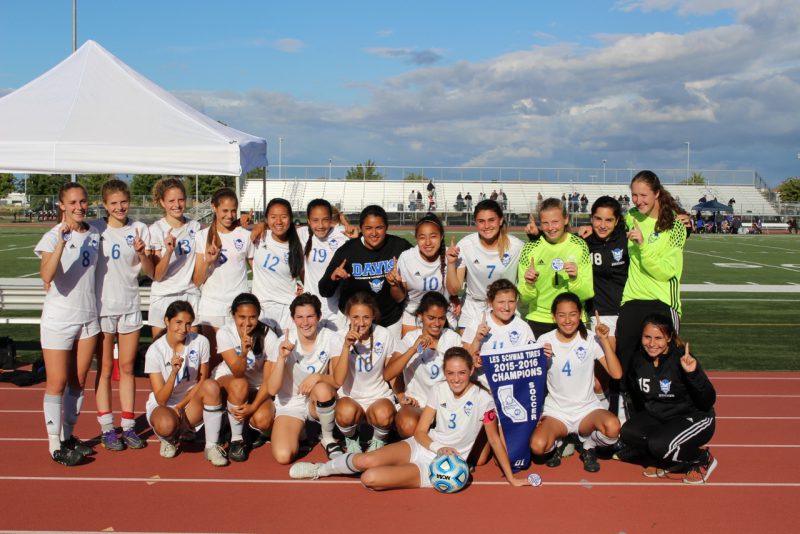 The undefeated Davis High women's soccer team poses with its section banner after a 1-0 section championship victory over Rocklin on Saturday, May 21. 