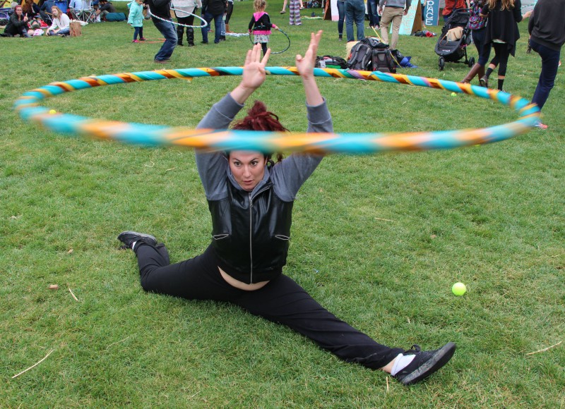 Junior at Natomas Charter School, Lexi Korblum, shows off her flexibility while hula hooping in the field between pathways at Whole Earth.