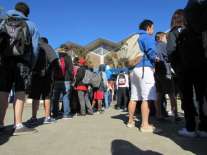 Students wait in line to get lunch at the food truck. 