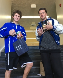 Sophomore Jake Goidell and senior Matteo Sorrentino collect cans on Nov. 18 to donate to STEAC.