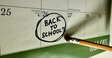 The back of a pencil points to the date Aug. 26 marked with a circled "back to school" in black ink