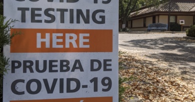 A sign in front of the Davis Senior Center reading "COVID-19 Testing Here Prueba De COVID-19 Aquí"