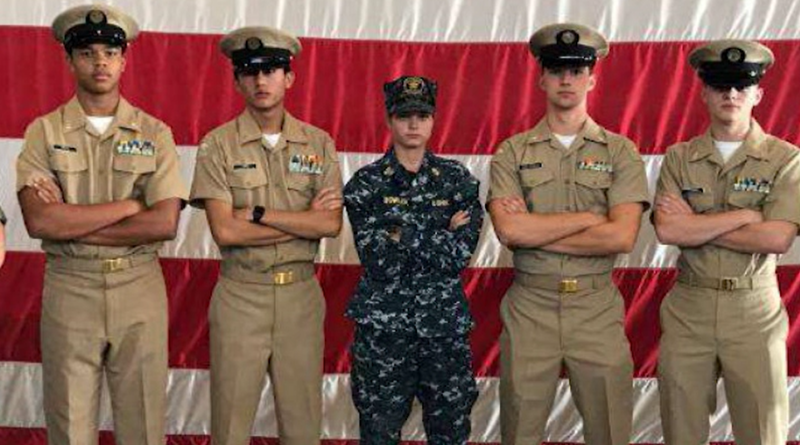 Charlotte Bowler wearing her Coast Guard damage controlman uniform with two cadets on either side