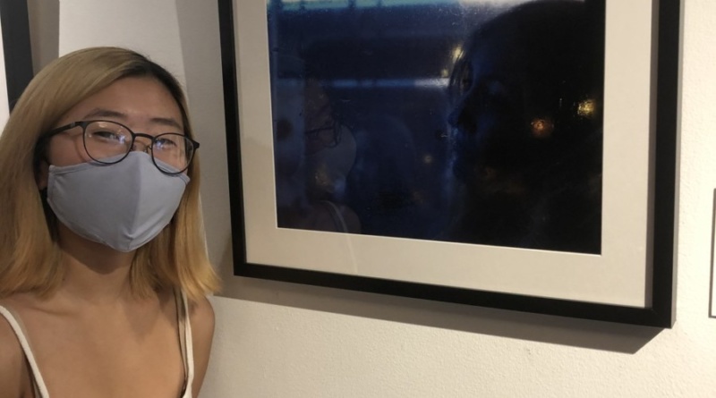 Alicia Joo in front of her displayed photo