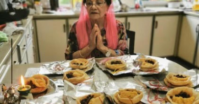 An older Indian woman blessing food
