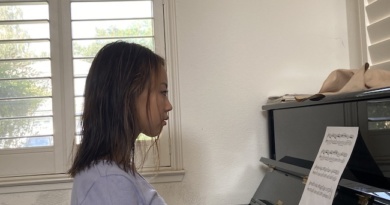 Emily Jiang sits at a piano, posed to play.