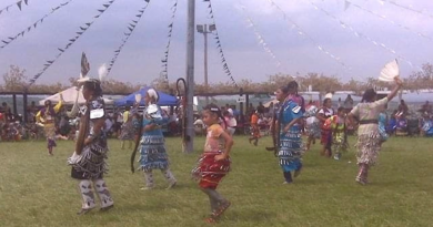 A Native American tribe celebrating indigenous cultures by dancing