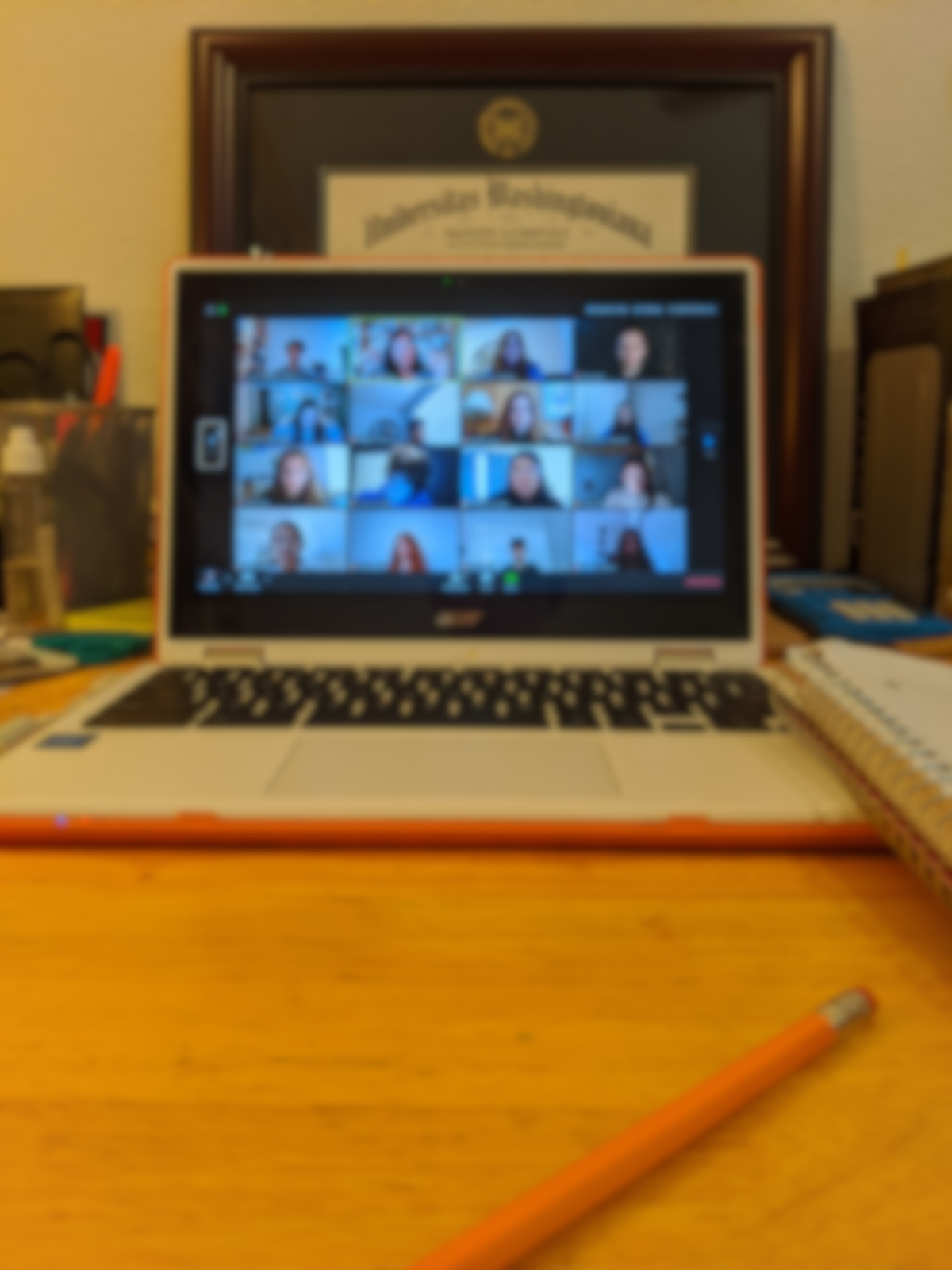 A blurred out Zoom meeting running on a laptop