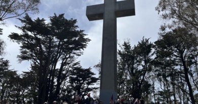 people beneath a cross